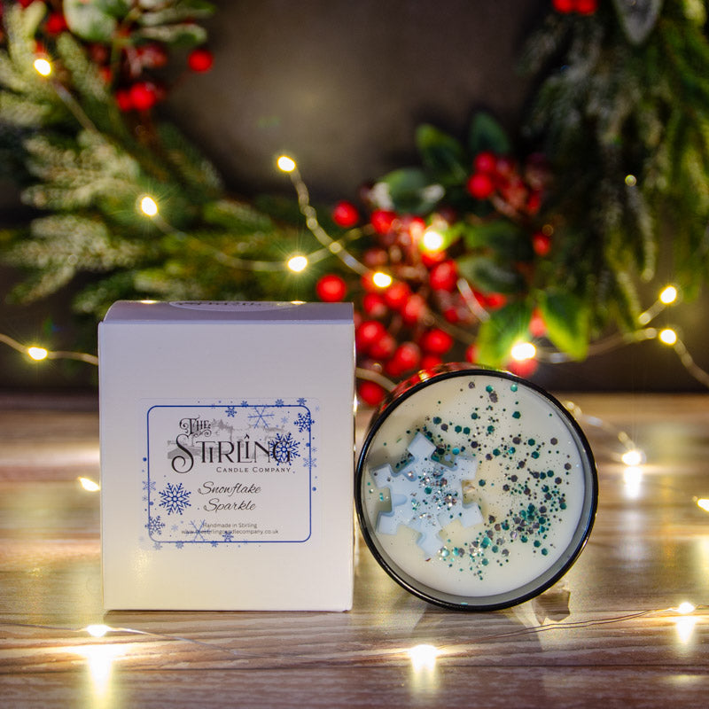 Black candle in the fragrance Snowflake Sparkle with matching box