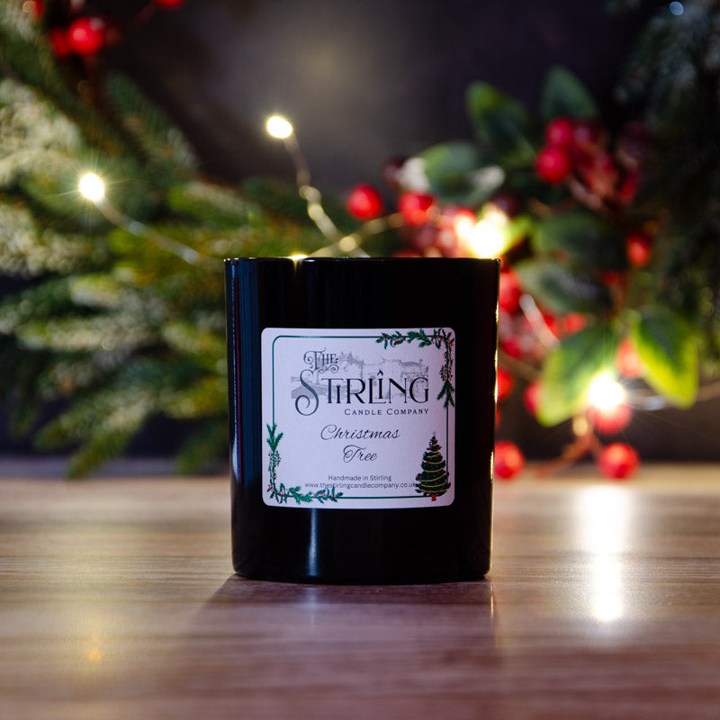 Black candle in the fragrance Christmas Tree, side view