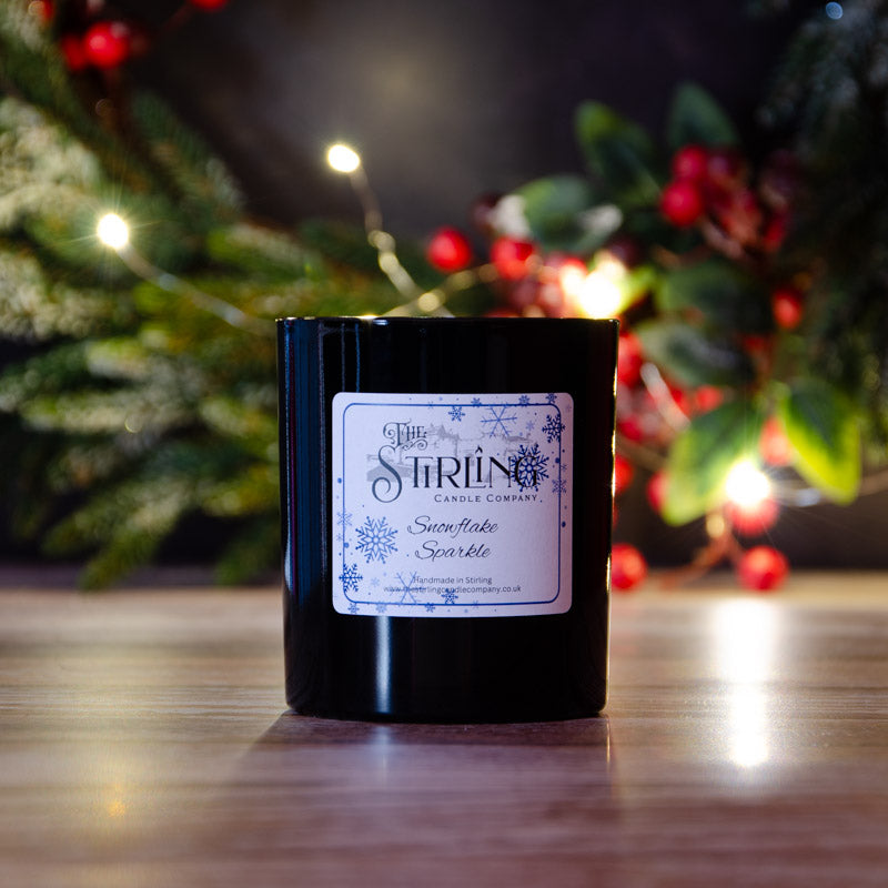 Black candle in the fragrance Snowflake Sparkle, side view