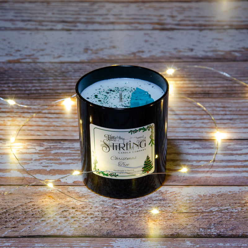 Black candle in the fragrance Christmas Tree, top view