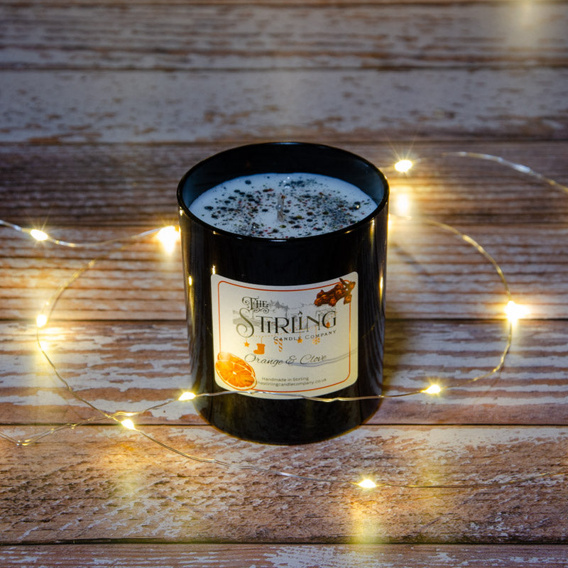 Black candle in the fragrance Orange and Clove, top view