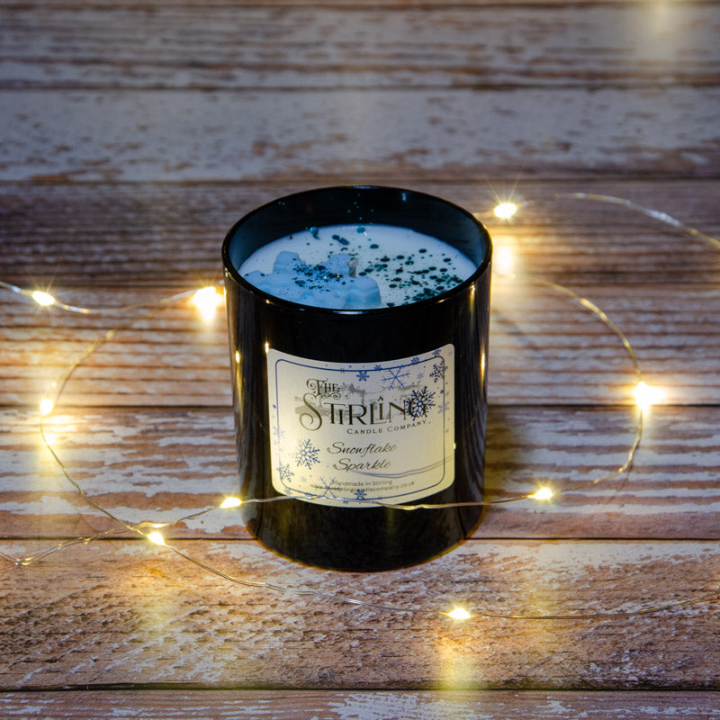 Black candle in the fragrance Snowflake Sparkle, top view