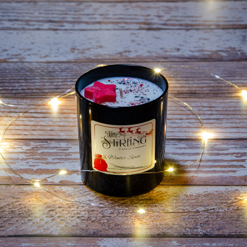 Black candle in the fragrance Winter Spice, top view