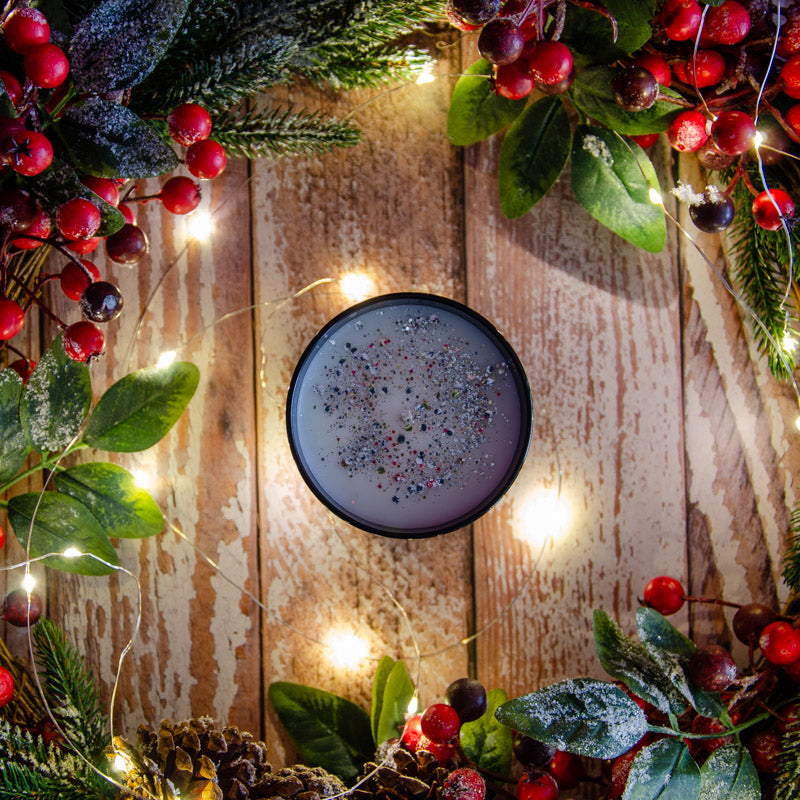 Black candle in the fragrance Orange and Clove, top down view