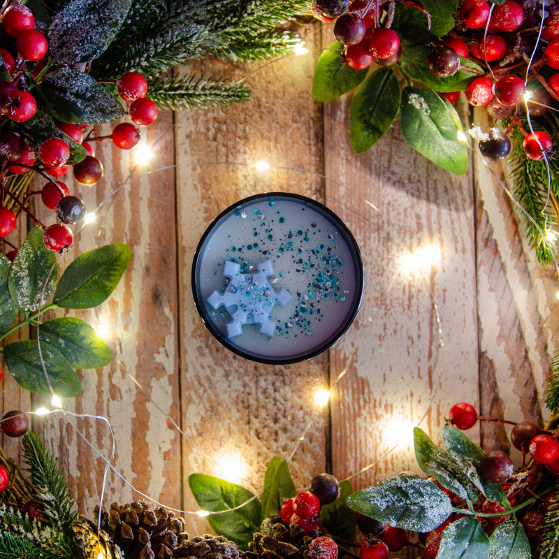 Black candle in the fragrance Snowflake Sparkle, top down view