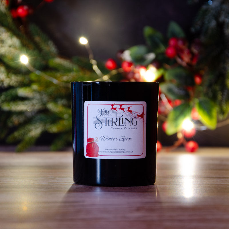 Black candle in the fragrance Winter Spice, side view