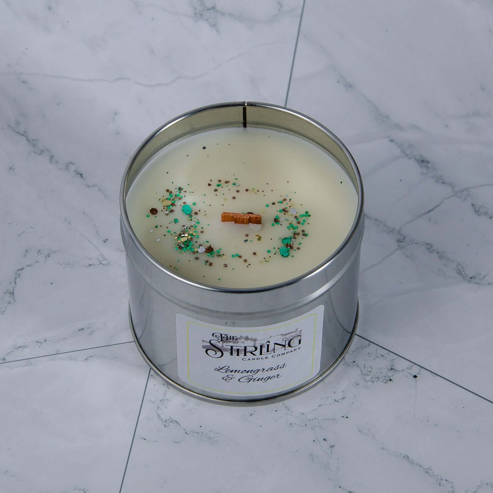 Lemongrass & Ginger travel tin candle top down view showing the glitter